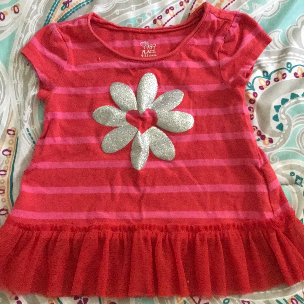 A striped pink and red shirt with red ruffles